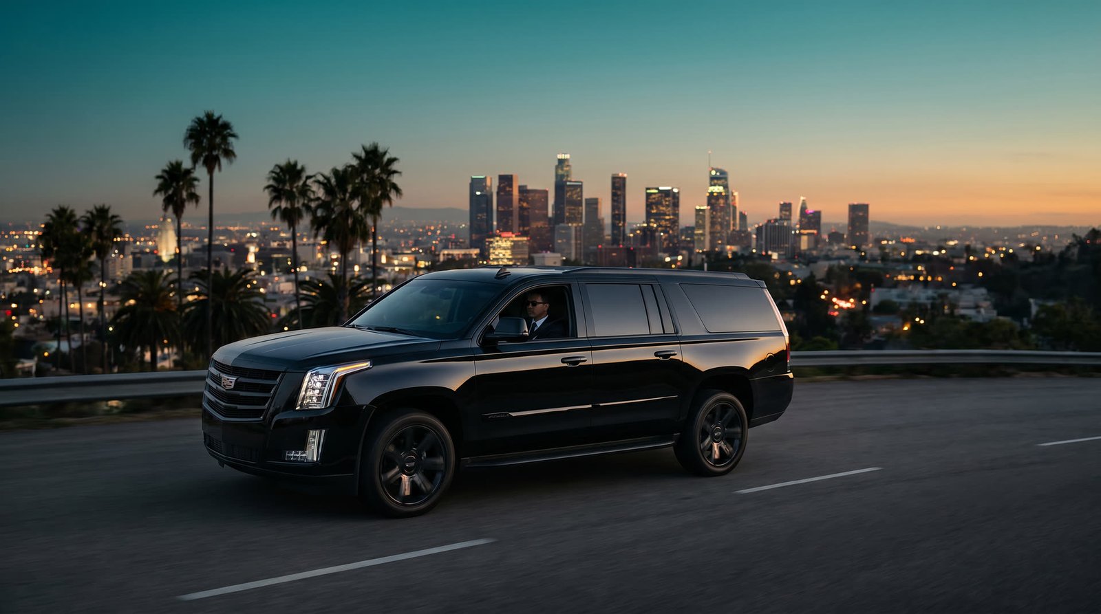 Luxury SUV cruising Mulholland Drive at dusk